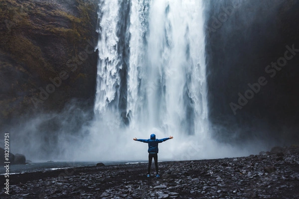 Obraz A person admirnig the beauty of Skogafoss waterfall located in Iceland