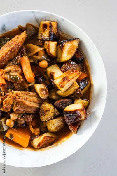Obraz veggie stew bowl with roasted potatoes carrots zucchini and plant based chicken strips