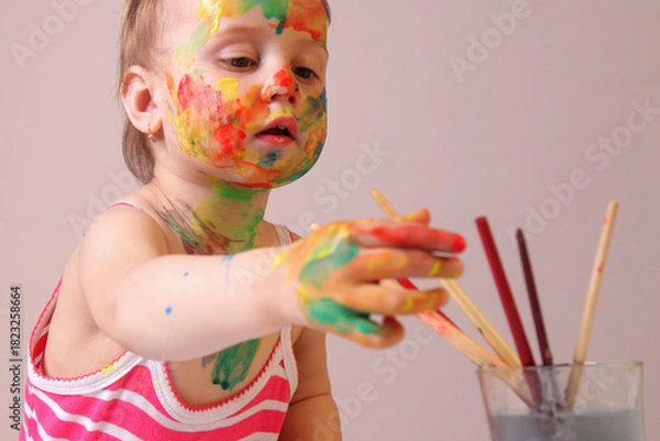 Fototapeta Toddler showing professional chaos-management skills