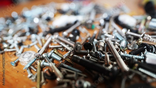Fototapeta Industrial hardware components: close-up of silver bolts and nuts