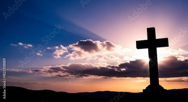 Fototapeta Cross silhouette against a vibrant and dramatic sunset sky with radiant sunbeams breaking through clouds, symbolizing hope, faith, spirituality and reflection.