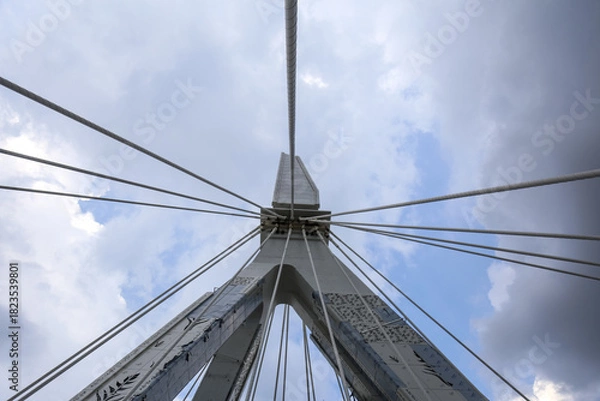 Obraz Cable-Stayed Bridge Pylon Viewed from Below Against Blue Sky