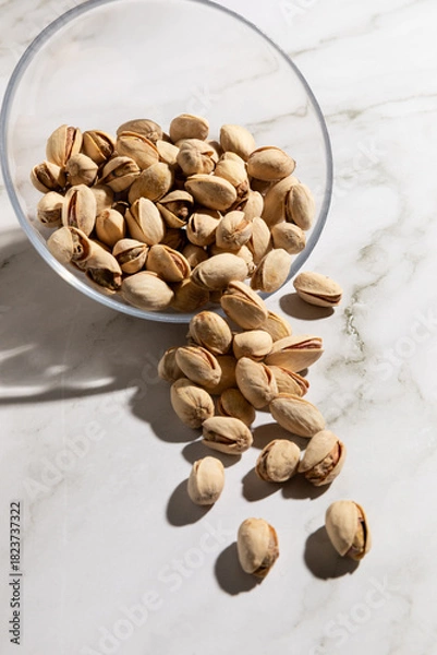 Fototapeta Bowl of pistachios isolated on countertop kitchen surface