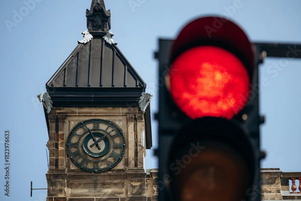 Obraz Montreal City Hall clock tower with Roman numerals and red traffic light in foreground