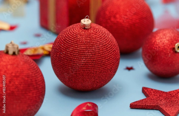 Obraz Red Christmas bauble close up, blue background