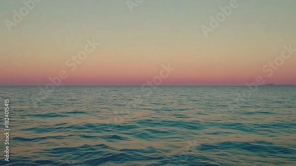 Obraz Vast ocean stretching to the horizon under a gentle gradient of twilight sky, reflecting tranquil water movement and a distant landmass