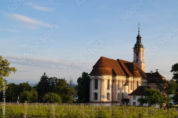 Obraz View of the baroque pilgrimage church Birnau with vineyard in the foreground with motion blur effect. Nussdorf, Lake Constance, Germany.