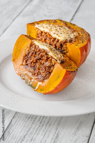 Fototapeta Portion of baked Hokkaido pumpkin with beef, tomato sauce, mozzarella cheese