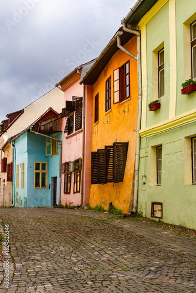 Obraz Cityscape. Old cobbled street with colorful buildings. Old town of Sighisoara, Transylvania, Romania