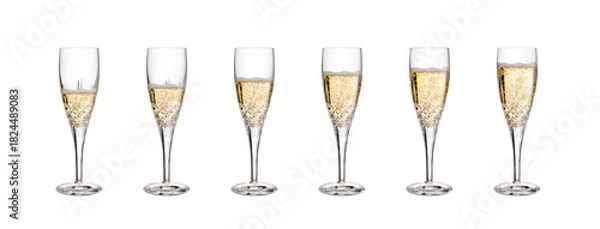 Fototapeta A collection of part full glasses of champagne, champagne flutes, fizzy wine, as a birthday celebration or to celebrate the New Year with against a isolated transparent background.