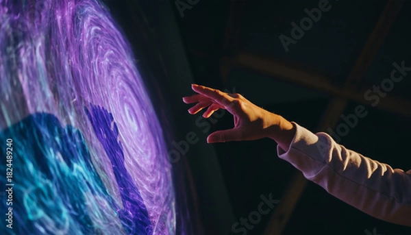 Fototapeta Hand Reaching for Swirling Galaxy Projection
