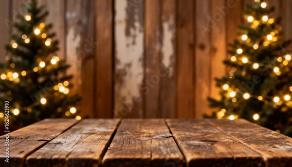 Fototapeta Wooden table in front of Christmas trees with warm lights