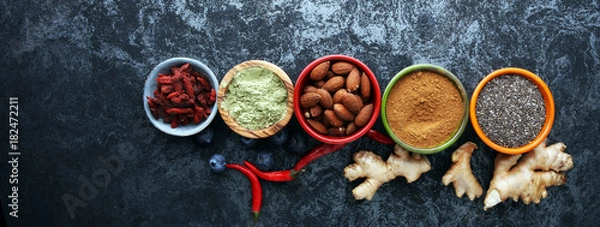 Fototapeta superfood concept with bowls in diffrent colors of various superfoods.