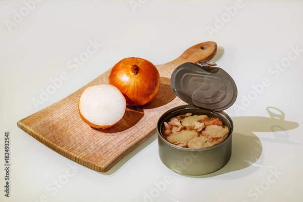 Obraz Fresh and soft canned tuna on the table, with a cutting board and onion