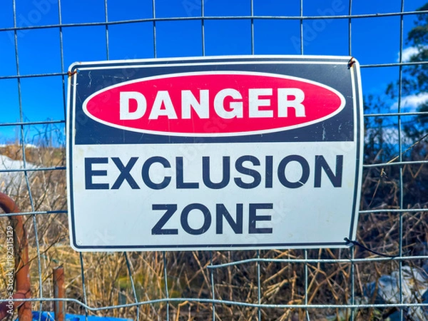 Fototapeta Photograph of a Danger Warning Sign on a fence barricade notifying people not to enter a small construction site in regional New South Wales, Australia. 