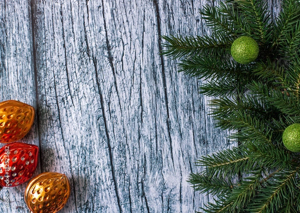 Obraz Branches of spruce with Christmas decorations on a background of old wooden panels, Christmas and New year background