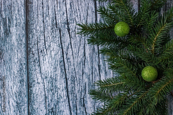 Obraz Branches of spruce with Christmas decorations on a background of old wooden panels, Christmas and New year background