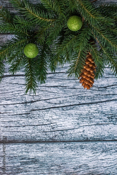 Obraz Branches of spruce with Christmas decorations on a background of old wooden panels, Christmas and New year background