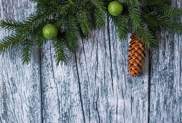 Obraz Branches of spruce with Christmas decorations on a background of old wooden panels, Christmas and New year background