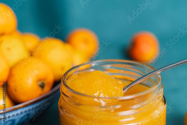 Obraz Yellow fruit jam in jar with spoon