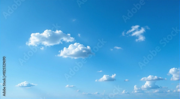 Fototapeta Fluffy Clouds Against a Bright Blue Sky A Peaceful Daydream