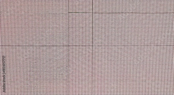 Fototapeta Detailed close up of a red and white checkered fabric pattern with intersecting lines and a textured surface