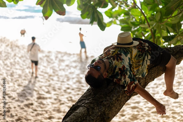 Obraz Man laying on tree., nusa penida, bali. High quality photo