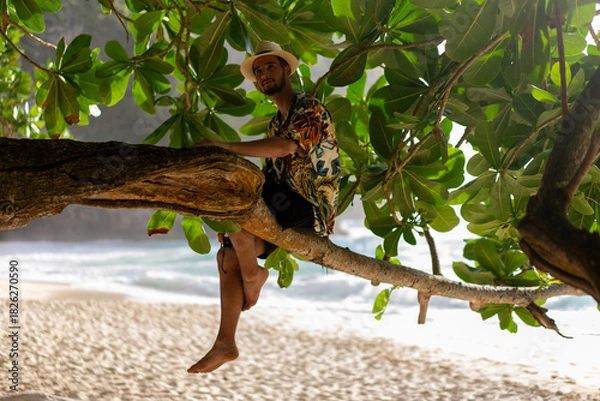 Obraz Man laying on tree., nusa penida, bali. High quality photo