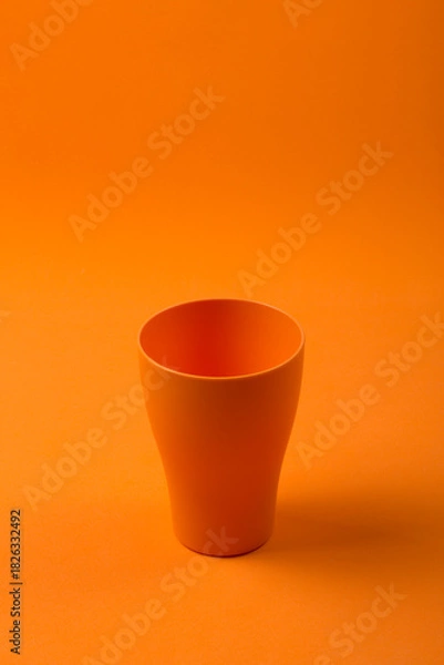 Obraz Orange cup on an orange background