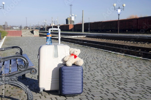 Fototapeta Suitcase and Travel Accessories on Empty Train Platform