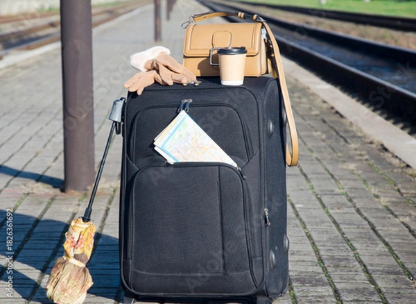 Fototapeta Suitcase and Travel Accessories on Empty Train Platform