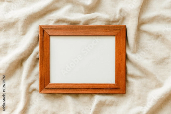 Fototapeta Blank wooden frame on soft fabric background for elegant interior mockup