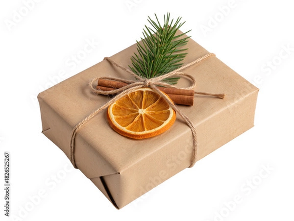 Obraz Christmas gift box wrapped in kraft paper and decorated with dried orange, cinnamon sticks and fir branch. Isolated on white or transparent background.