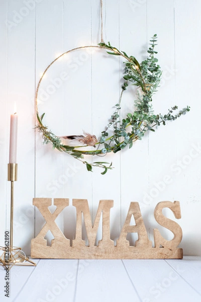 Fototapeta Golden "XMAS" Letters with Dried Flower Wreath and Candle on White Background