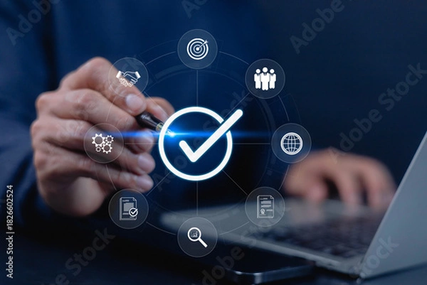 Fototapeta A businessman using a digital interface with a glowing check mark symbol, representing approval, quality assurance, verification, and modern business standards for reliable workflow management.