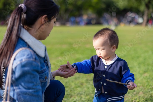 Fototapeta Happy baby playing with mother at park