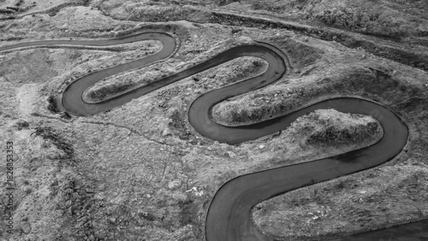 Fototapeta Aerial black and white view of a winding mountain road