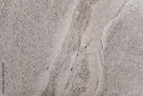 Obraz The stone is a mix of grey and white, with a white line running through it. The line is not very prominent, but it is noticeable. The stone is likely a type of marble or granite