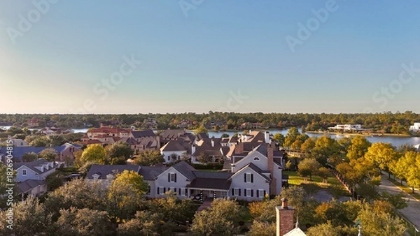 Obraz Aerial view of large mansion houses with swimming pool,  in affluent neighborhood  by Woodlands lake, Houston, Texas, expensive suburban homes surrounding by lush green trees, USA