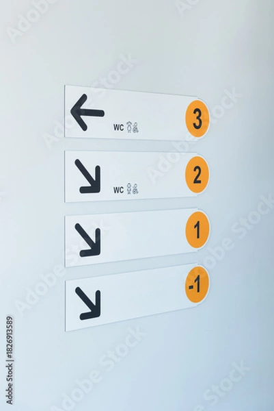 Fototapeta Clear directional signs guide visitors through a multi-level building to facilities