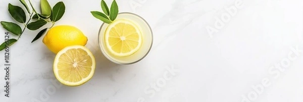 Obraz Fresh lemonade with lemons and green leaves on white marble background. Healthy organic summer drink