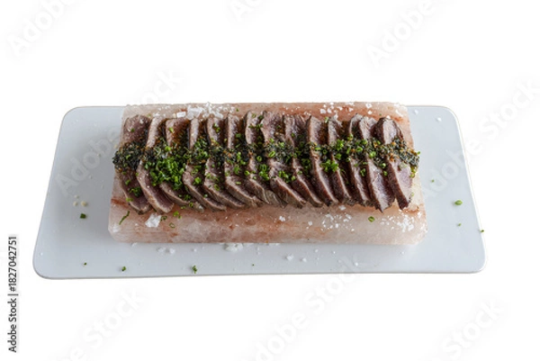 Obraz Slicing seared tuna with chives on himalayan salt block