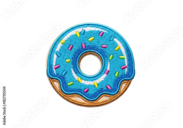 Fototapeta Detailed macro of an embroidered donut fabric patch with bright blue satin stitching and neon pop-art sprinkles, isolated on a white background with copy space. Concept of playful textile craft