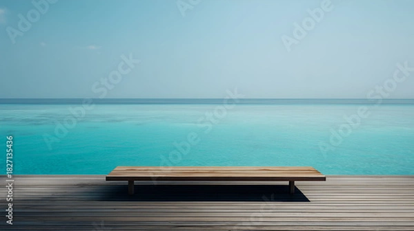 Fototapeta Bench on sunlit deck faces calm turquoise sea. Clear sky and ocean hues evoke clarity, reflection, and editorial serenity in minimalist travel and nature storytelling.