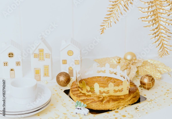 Fototapeta Fresh royal galette with crown and plates lie on the table.