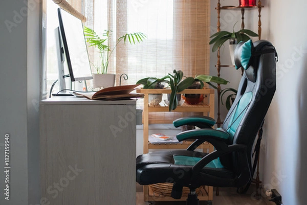 Fototapeta Home office workspace featuring computer desk and gaming chair