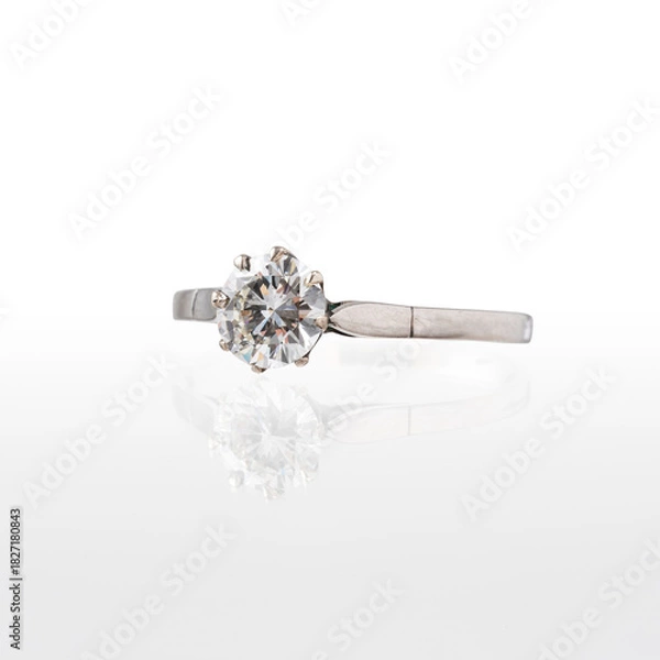 Obraz White gold solitaire ring with central diamond photographed on a white background with reflection