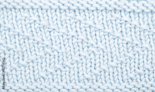 Fototapeta Sweater or scarf texture large knitting. Knitted jersey background with a relief pattern.  Wool hand-knitted or machine knitting pattern. Fabric Background. blue knitted texture.