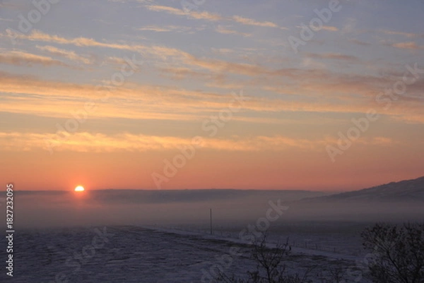 Fototapeta Crisp and Cold Sunrise in the Fog Covered Valley.