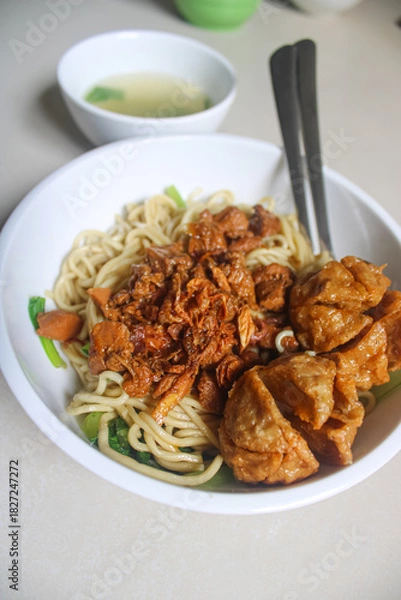 Fototapeta Indonesian Chicken Noodle (Mie Ayam) with Fried Meatballs and Broth